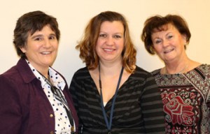Three Janesville public school teachers smile in front of white background