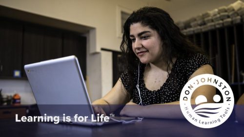 Girl working on laptop with headphones and the Learning is for Life logo