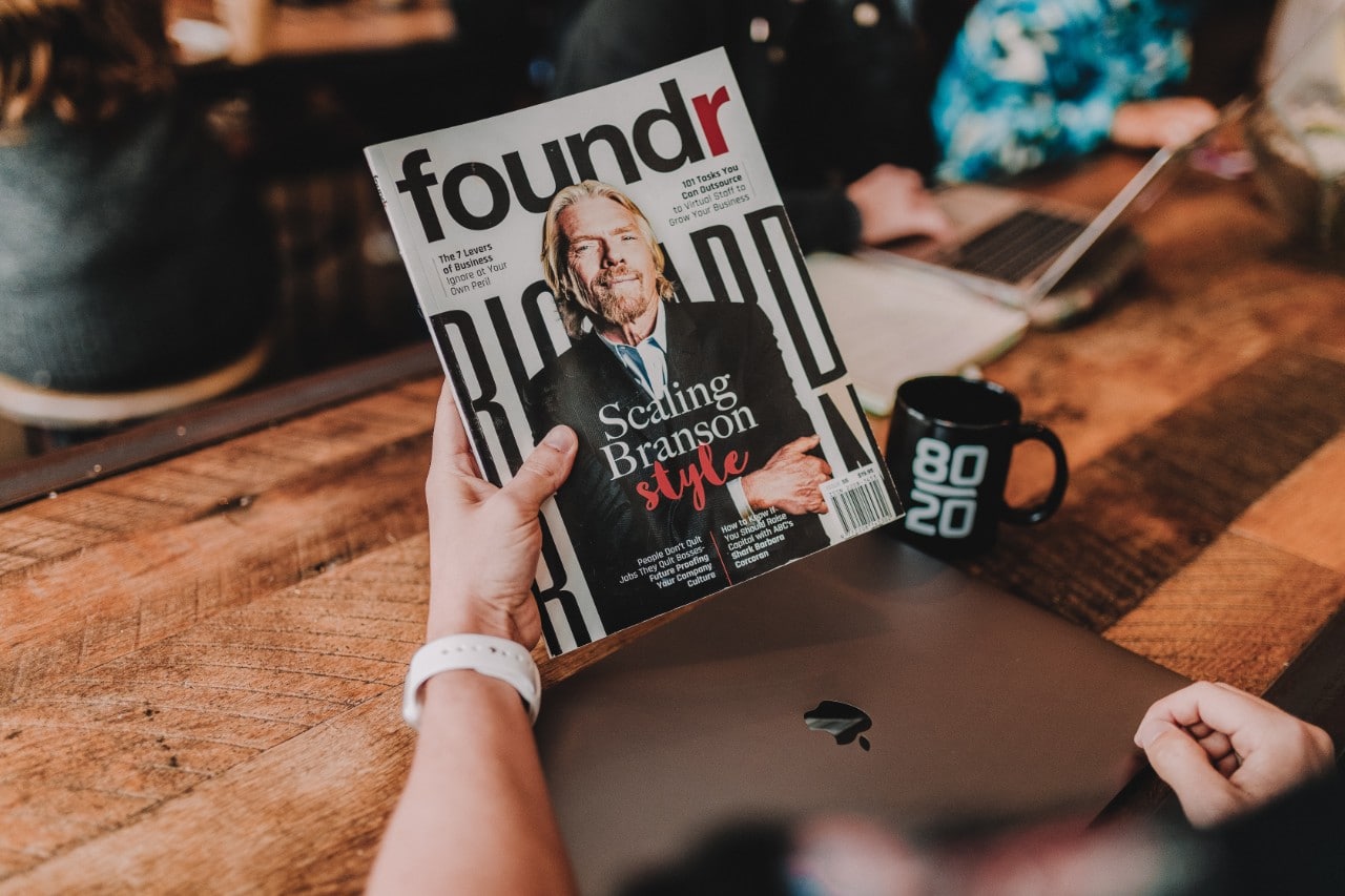 Person holding a magazine with Richard Branson on the cover
