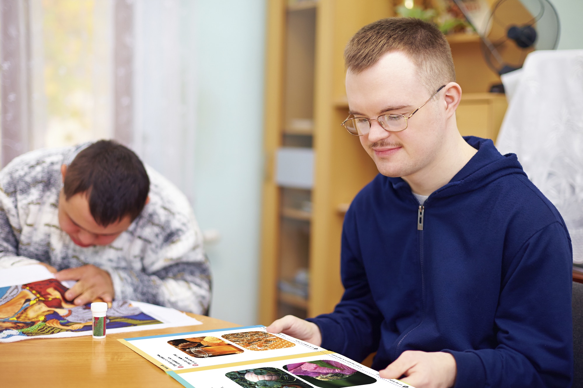 Student with Special needs looking at a readtopia graphic novel