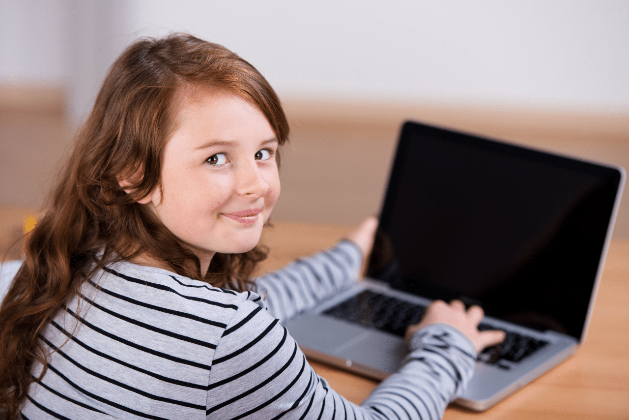 Girl in striped shirt studying on a laptop