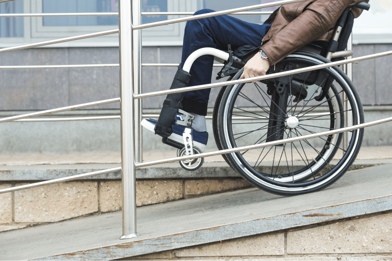 Man in a wheelchair use a wheelchair ramp