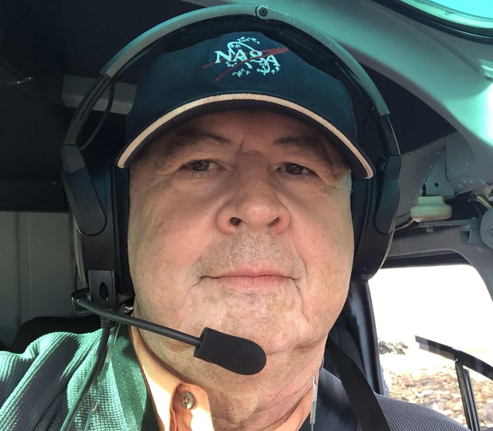 Headshot of Don sitting in a cockpit wearing a NASA hat and a communication headset.