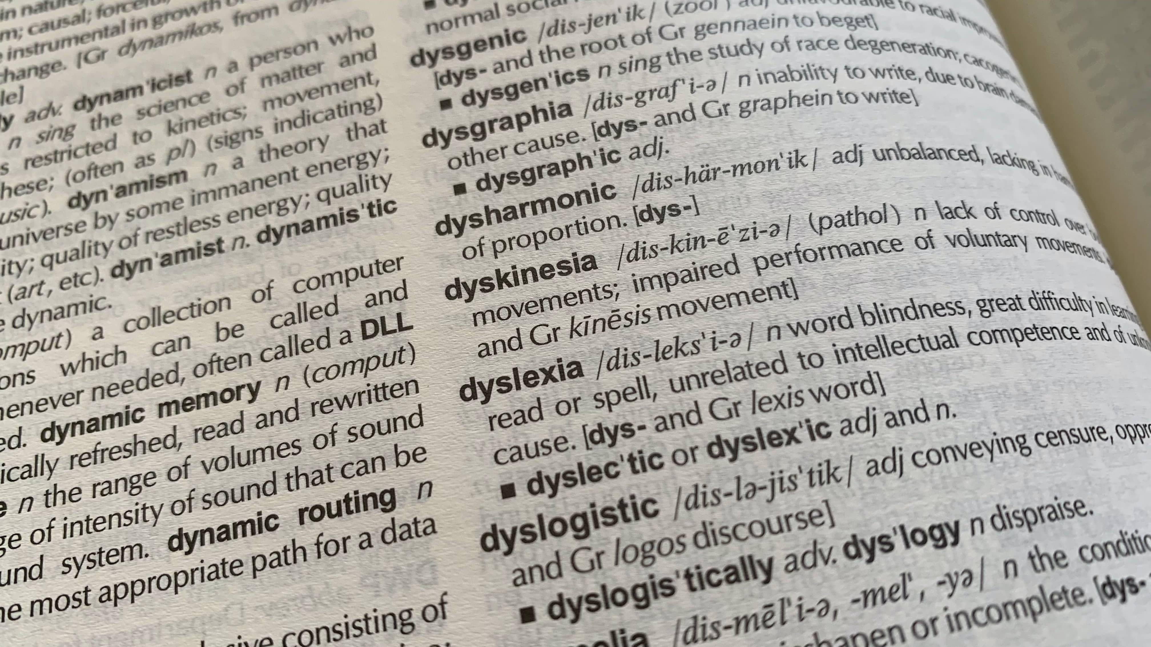 An open dictionary with the word "dyslexia" in focus.